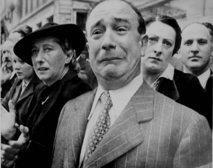 A french citizen cries as German soldiers march in Paris durin the French Occupation