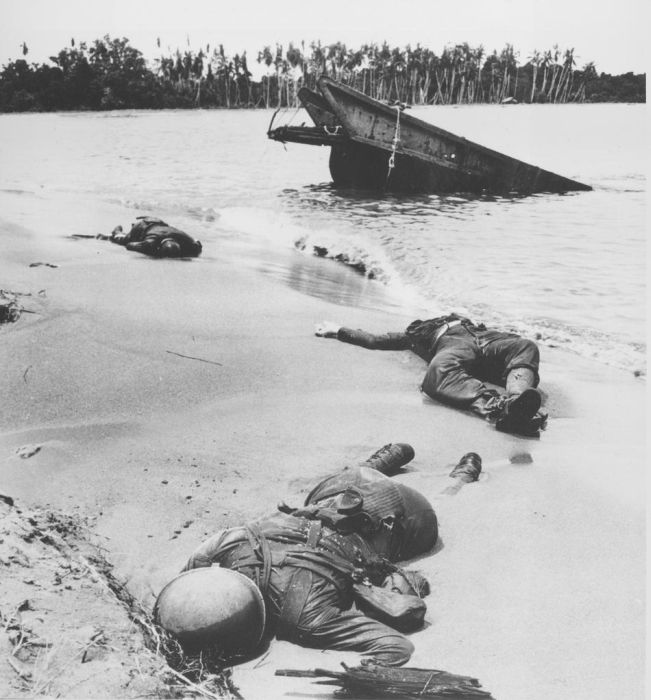 Buna Beach, New Guinea February 1943. The first picture of American Casualties to ever be shown in the newspaper back in the States.