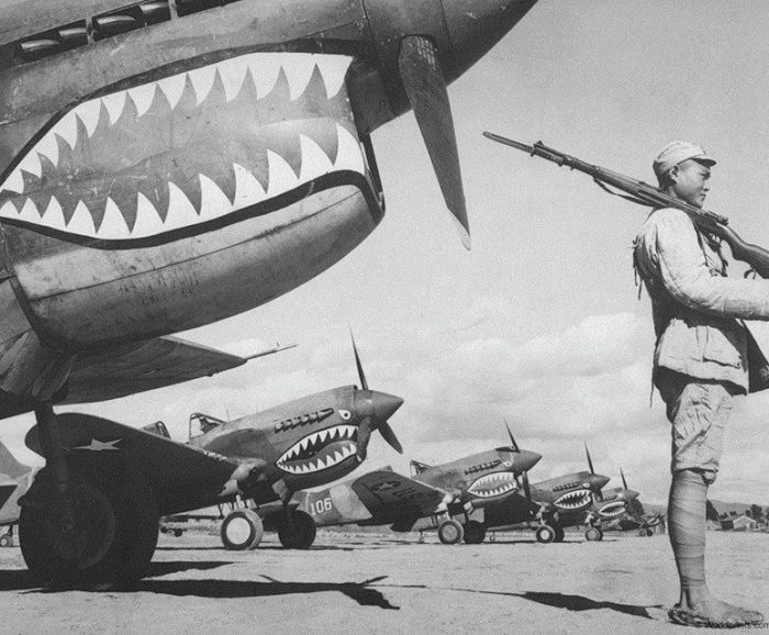 Chinese soldier guarding P-40 Warhawk fighters of the AVG 'Flying Tigers', China, circa 1942