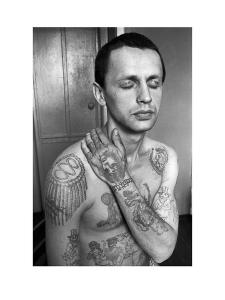 The tattoos across the eyelids read Do not  Wake me. The genie on the forearm is a common symbol of drug addiction. If an addict is imprisoned for drug offences, he or she will have to go through withdrawal in the zone prison. Epaulette tattoos on the shoulders display the criminals rank in a system that mirrors that of the army major, colonel, general etc.