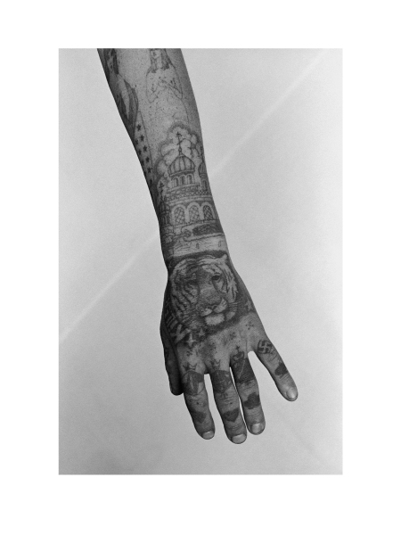 The tiger and the text Killer in English tattooed on the hand symbolise the bearer's aggression. His ring tattoos signify he is a high-ranking thief and an anarchist, who will never be corrected. In this colony they make and sell wooden items that are in great demand. He was killed by his fellow inmates for refusing to contribute money to the community kitty.