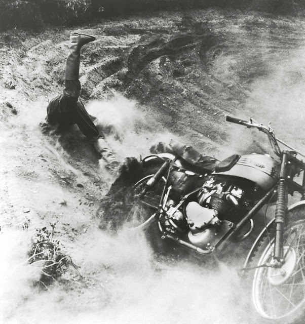 A competitor tumbles off his motorcycle during the Motorcross World Championship at the Volk Mlle race course.