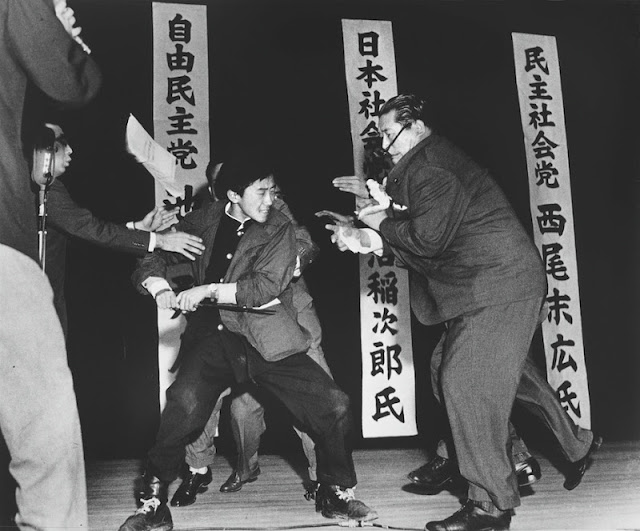 A right-wing student in Japan assassinates Inejiro Asanuma, Socialist Party Chairman, during his speech at the Hibiya Hall