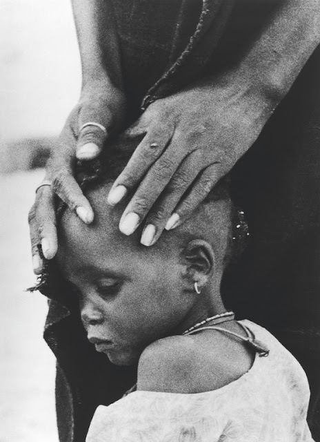 The Faces of Hunger. A mother comforts her child, both victims of drought