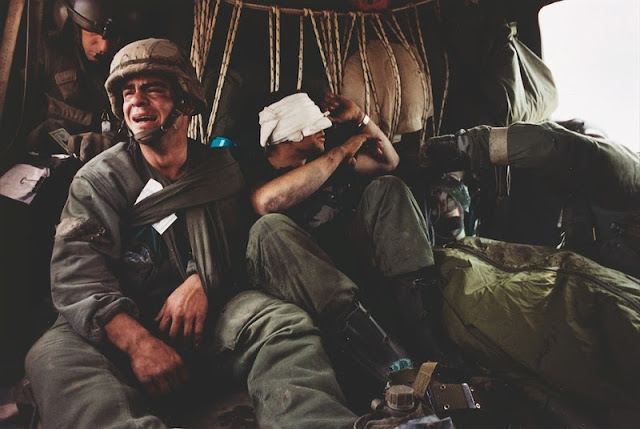US Sergeant Ken Kozakiewicz 23, gives vent to his grief as he learns that the body bag at his feet contains the remains of his friend Andy Alaniz. 'Friendly fire' claimed Alaniz's life and injured Kozakiewicz. On the last day of the Gulf War they were taken away from the war zone by a MASH unit evacuation helicopter.