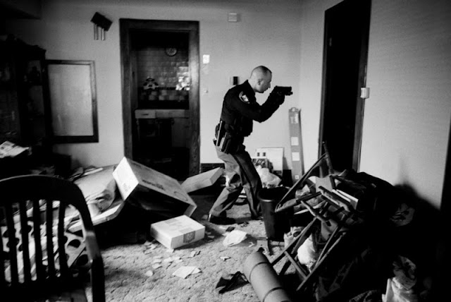 Detective Robert Kole of the Cuyahoga County Sheriff's Office enters a home, following mortgage foreclosure and eviction. He needs to check that the owners have vacated the premises, and that no weapons have been left lying around.