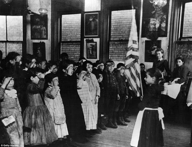 Children of Mott Street Industrial School, New York, salute the Stars and Stripes, and repeat the Oath of Allegiance
