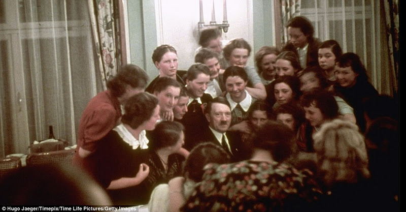 A group of Austrian schoolgirls crowd around to chat to Hitler