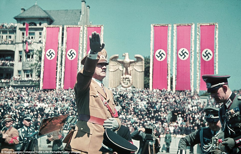 Hitler and his henchmen of the Legion Condor and aircraft division, the Luftwaffe, at a rally in Germany held in their honour in front of thousands of citizens under swastika banners