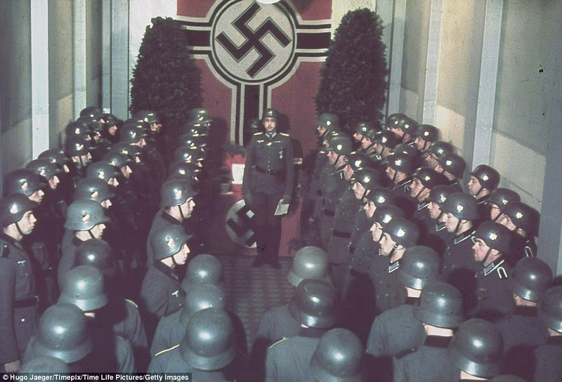 Solemn Nazi soldiers gather to celebrate the fascist leader's birthday at the West wall in Germany