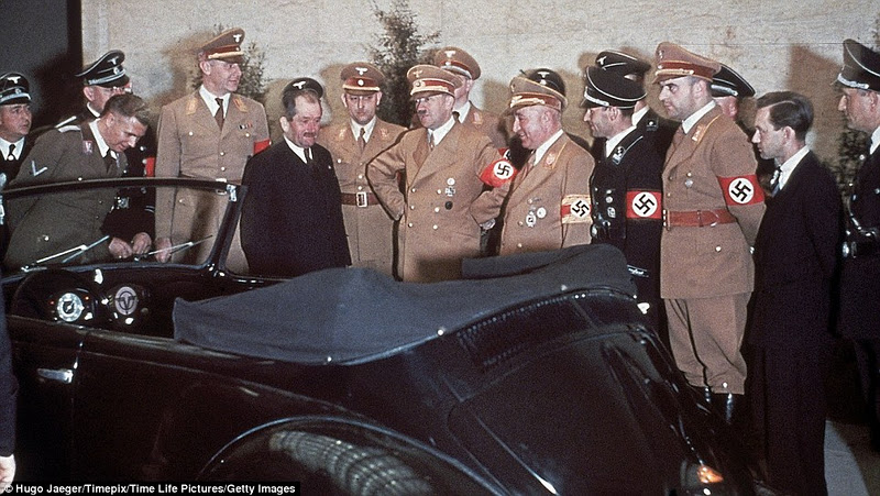 Austrian automobile manufacturer Ferdinand Porsche left, in dark suit presents a newly-designed convertible Volkswagen car to Hitler for his 50th Birthday in Berlin