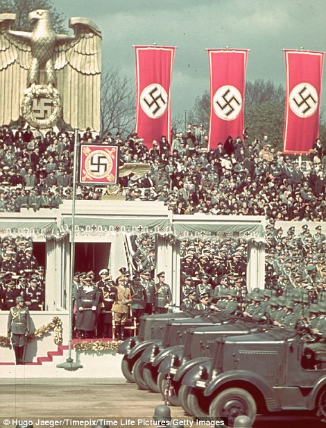 hitler watches as troops roll by at a military parade for his 50th birthday