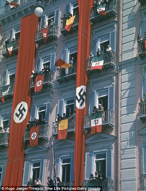 Nazi, German and Italian flags hang from balconies to welcome Hitler during state visit to Italy