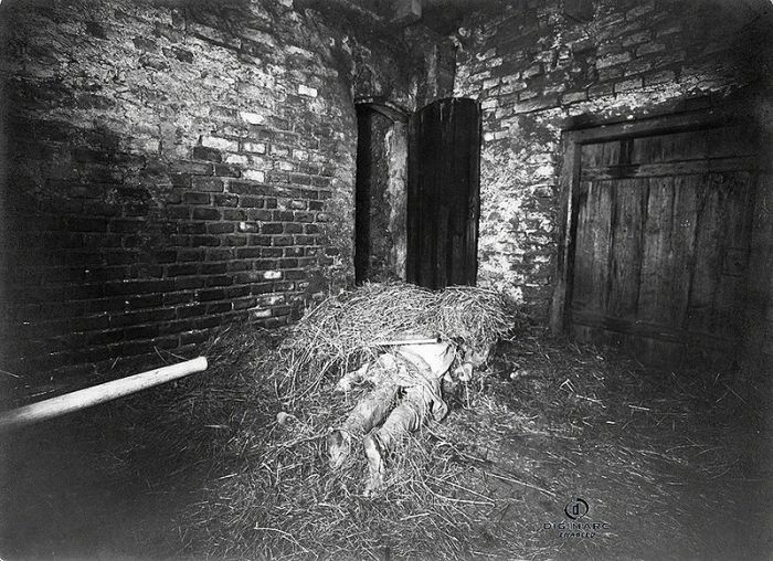 The Mysterious Hinterkaifeck MurdersIn Germany, 1922, the murders of six people at the Hinterkaifeck farmstead shocked the nation. This wasnt just because of the gruesome nature of the case, but also because the case was so incredibly weird, and it remains unsolved to this day. Over 100 people were interviewed in the murder, but no one was ever arrested. No motive was ever established as to explain the murders. The previous maid had left 6 months earlier, saying the home was haunted. The new maid arrived only hours before the murders. It is believed that the perpetrators remained at the farm for several days  someone had fed the cattle, and eaten food in the kitchen: the neighbours had also seen smoke from the chimney during the weekend. This photo depicts one of the victims as he lay in the house barn.