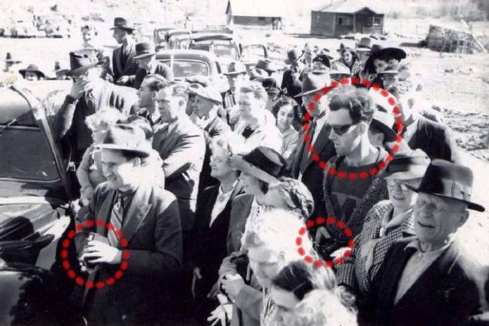 Time Traveling HipsterPeople believe that this photograph, taken in 1941 at the re-opening of the South Forks Bridge in Gold Bridge, Canada, is depicting a man in seemingly modern dress and style, with a camera that is advanced well beyond its time. The circle on the left illustrates a man with a camera typical to the time-period