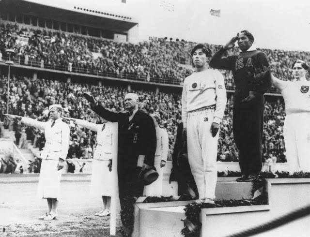 Jesse Owens on the podium at the 1936 Berlin Olympics, after winning one of his four gold medals at the games - 1936