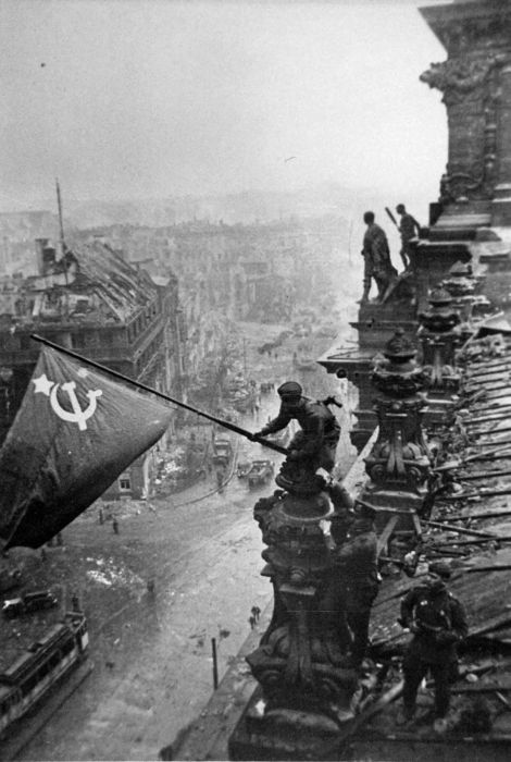 Soviet Union soldiers raising the flag on the roof of Reichstag building in Berlin, Germany in May, 1945