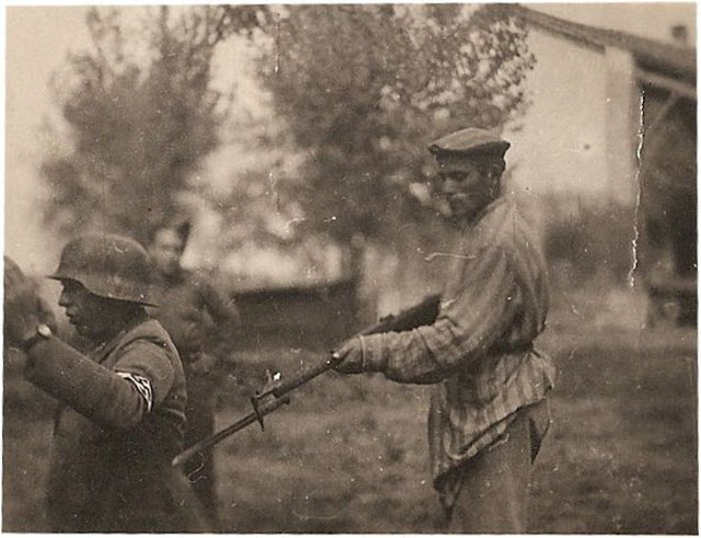 Liberated Jewish man holds NAZI soldier at gunpoint during WWII, unknown date