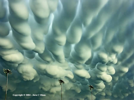 Mammatus Clouds    Also known as mammatocumulus, meaning "bumpy clouds", they are a cellular pattern of pouches hanging underneath the base of a cloud. Composed primarily of ice, Mammatus Clouds can extend for hundreds of miles in each direction, while individual formations can remain visibly static for ten to fifteen minutes at a time.