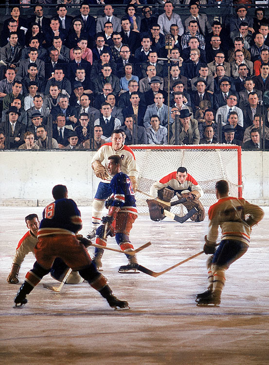 Montreal Canadiens goalie Jacques Plante surveys the ice without a mask during a game between the Canadiens and the New York Rangers at Madison Square Garden. Plante was the first NHL goalie to wear a goaltender mask on an everyday basis, a practice he started during the 1959-60 season.