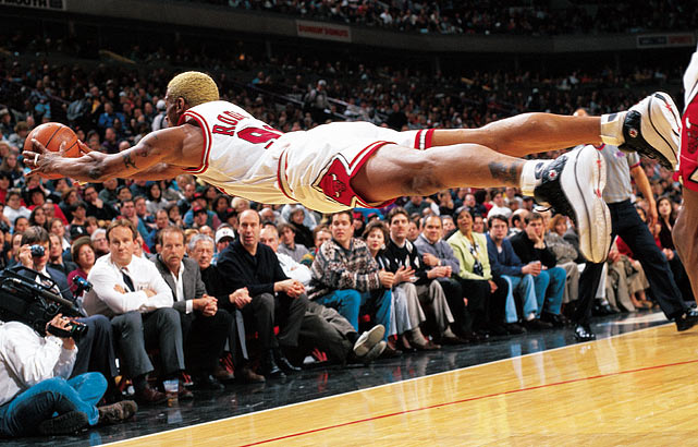 Chicago Bulls power forward Dennis Rodman goes horizontal for a loose ball during a game against the Pacers at the United Center in Chicago, Ill. Rodman won his sixth rebounding title during the 1996-97 season averaging 16.1 total rebounds a game.