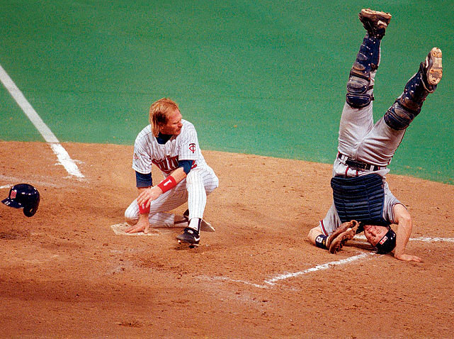 Atlanta Braves catcher Greg Olson goes head over heels after tagging Minnesota left fielder Dan Gladden out at home during Game 1 of the 1991 World Series. The Twins would win Game 1, 5-2, and go on to win the Series in seven games