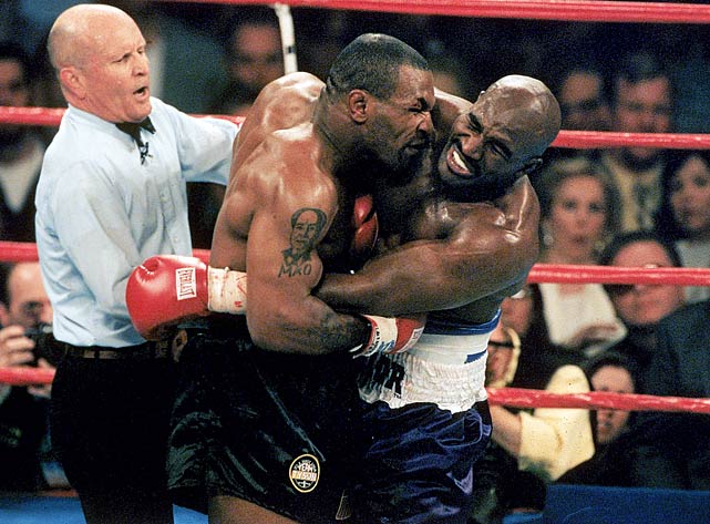 Mike Tyson bites the ear of Evander Holyfield during their 1997 heavyweight fight. Tysons boxing license was temporarily revoked for the incident and he was fined 3 million