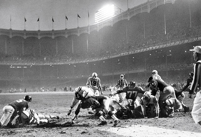 Baltimore Colts fullback Alan Ameche plows through New York Giants defensive back Jim Patton for the winning touchdown in overtime of the 1958 NFL Championship Game, otherwise known as The Greatest Game Ever Played.