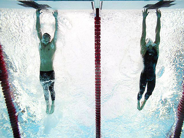 American swimmer Michael Phelps out-touches Serbian swimmer Milorad Cavic by 0.01 seconds at the finish of the 100-meter butterfly final. It was the seventh of Phelps record eight golds during the Olympics.