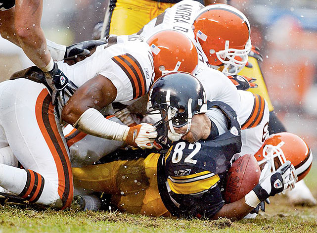 Pittsburgh receiver Antwaan Randle El has his head turned around as Chris Akins 36 of the Cleveland Browns is called for face masking. The Steelers defeated the Browns 36-33 during the AFC Wild Card Playoff game on Jan. 5, 2003, at Heinz Field in Pittsburgh.