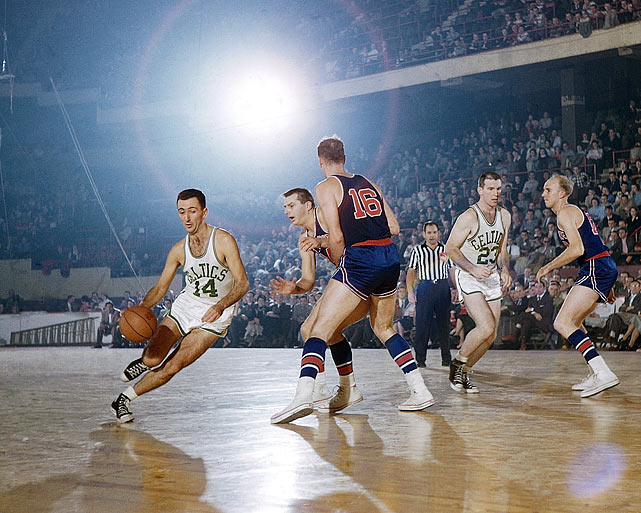 Boston Celtics point guard Bob Cousy drives by two Fort Wayne Pistons defenders during a game in 1955. Cousys unorthodox style, featuring behind-the-back dribbling and no-look passes, stood in marked contrast to the rest of the league, which was then dominated by a more fundamental style of play.