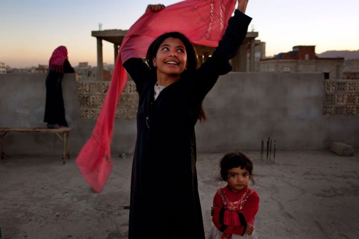 10 year old Yemeni girl smiling after she was granted a divorce from her husband - a grown adult.