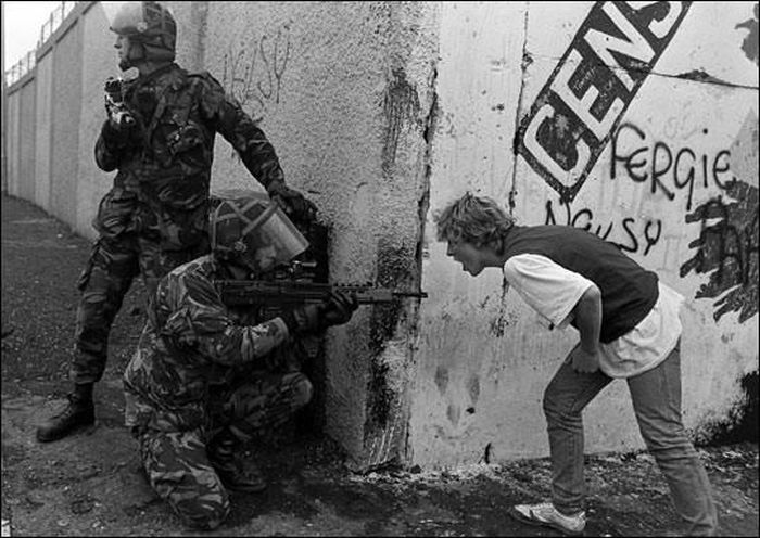 An Irish teenager yells at British soldiers during unrest in Northern Ireland