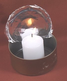 Make an inexpensive candle lantern out of a used tuna can and a candle.