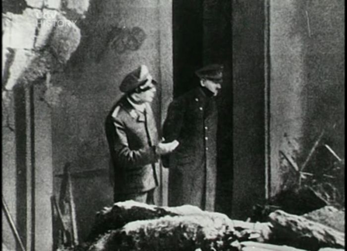The last photo taken of Adolf Hitler as he overlooks the damage in Berlin,1945
