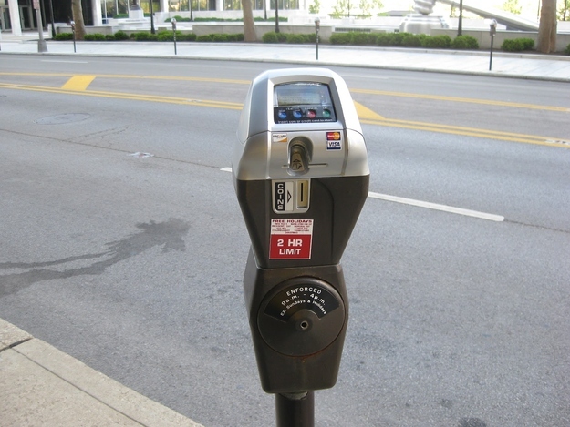Finding a parking meter with time left on it.