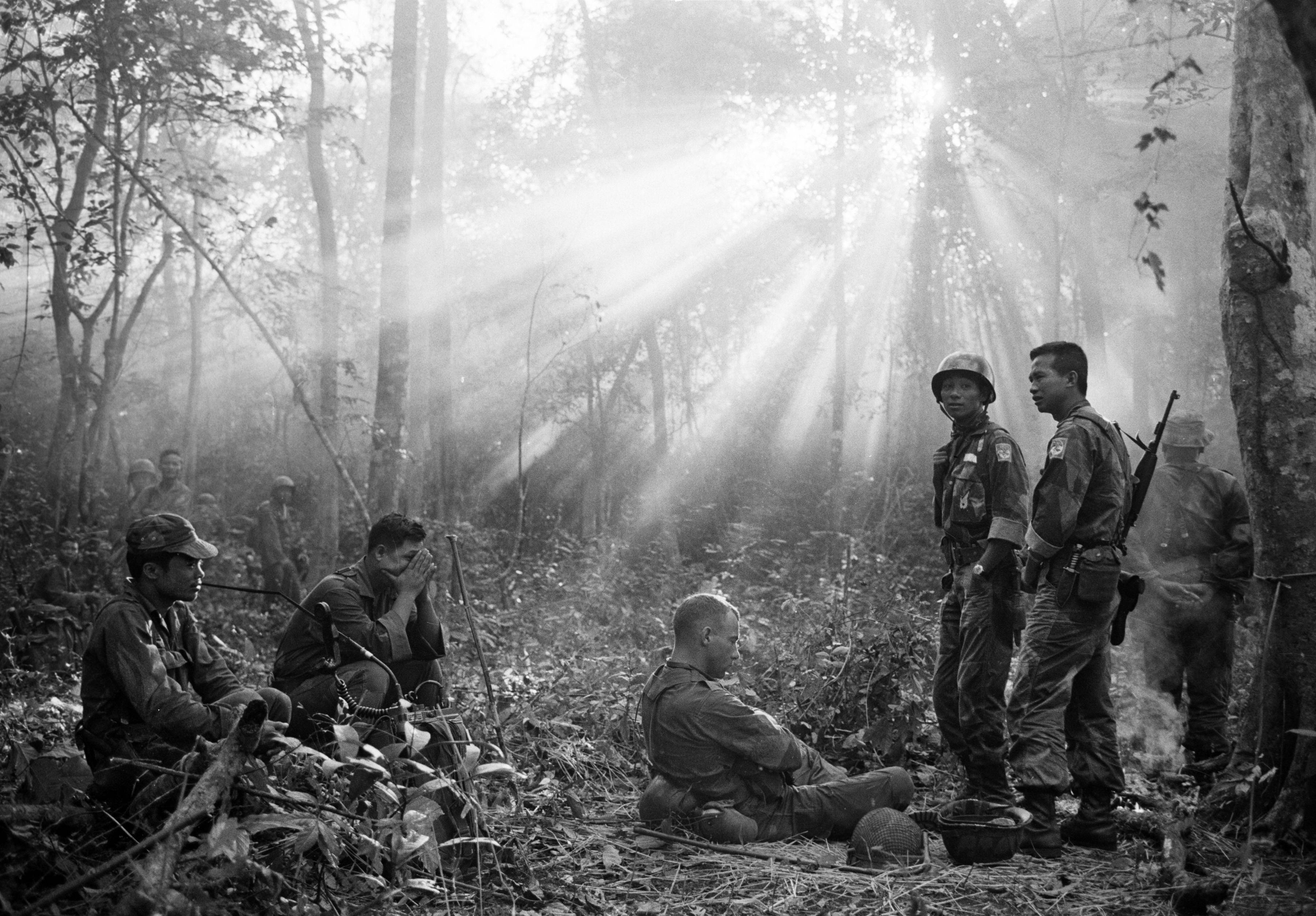 Horst Faas picture of Vietnamese and US troops rest after a tense night awaiting a Viet Cong ambush near the village of Binh Gia. January 1965