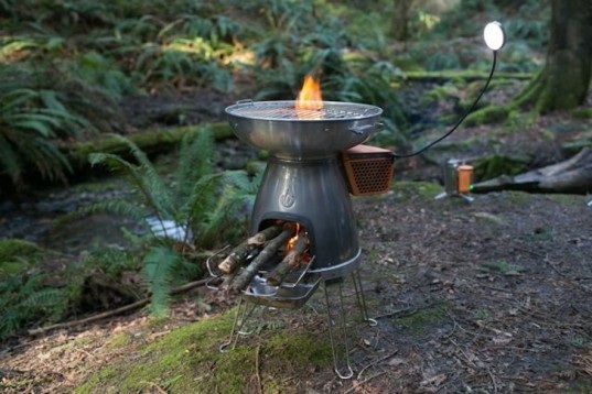 This camping stove grills your food and generates power from the heat to run its own light and charge or run any other USB device all on a handful of sticks.