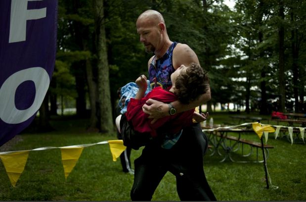 This guy runs in a local triathlon every year with his 13 year old daughter. She has cerebral palsy  he pulls her in a kayak during swim, in a cart during the bike and pushes her wheelchair for the run
