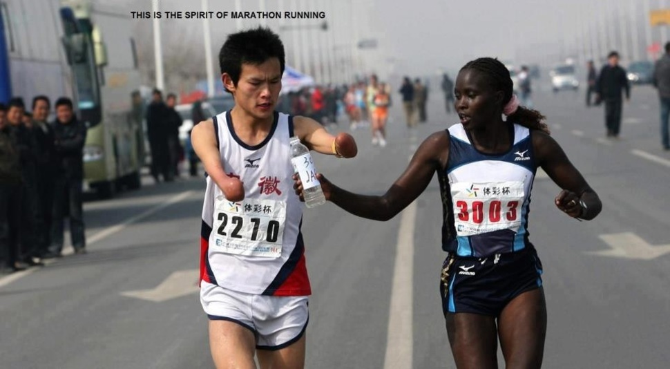 Elite runner Jaqueline Kiplimo helps a disabled Chinese athlete drink during the 2010 Zheng-Kai marathon. She stayed with him for several miles, costing her the 1st place finish and the 10000 prize
