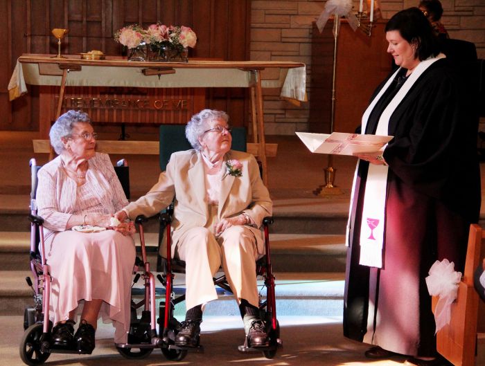 In this Sept. 6, 2014 photo, Rev. Linda Hunsaker presides over the wedding of Vivian Boyack left and Alice Dubes center, in Davenport, Iowa. More than seven decades after beginning their relationship, Boyack, 91, and Dubes, 90, finally got married.