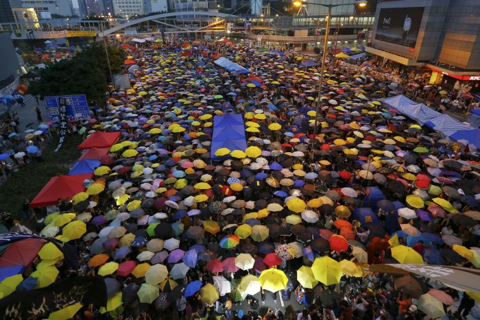 Protesters open their umbrellas, symbols of pro-democracy movement, as they mark one month since they took to the streets in Hong Kongs financial district on Oct. 28.