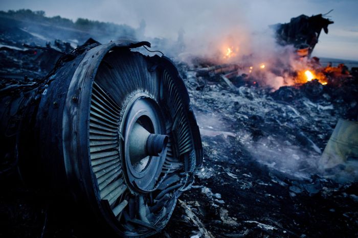 Smoldering debris from Malaysia Airlines Flight 17 in a Ukraine field