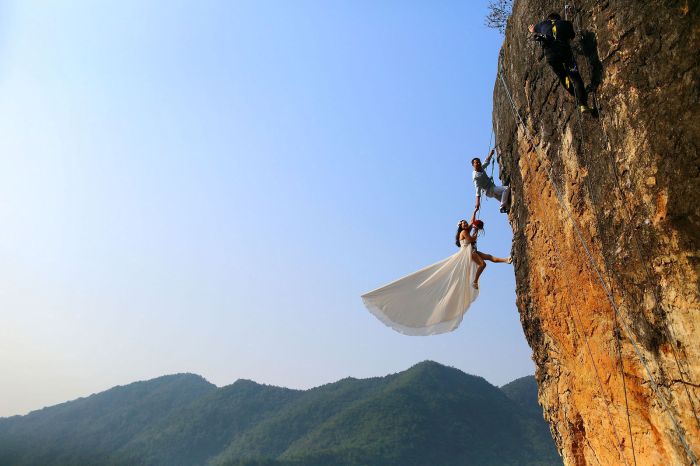 Zheng Feng, an amateur climber, takes wedding pictures with his bride on a cliff in Jinhua, Zhejiang, province, China, on Oct. 26.