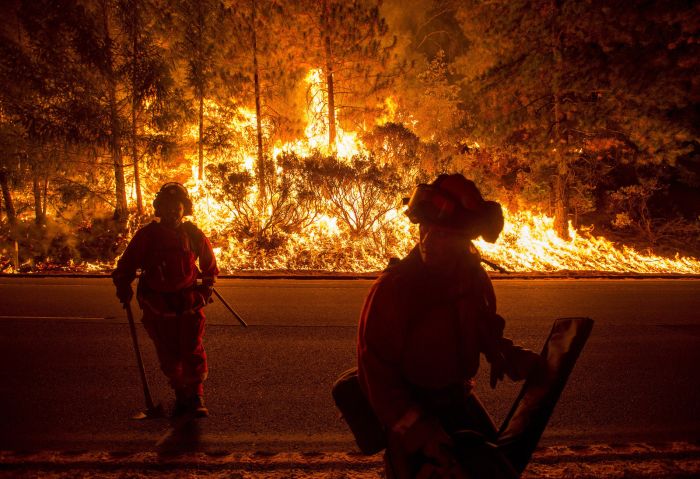 Firefighters battling the King Fire watch as a backfire burns along Highway 50 in Fresh Pond, California, on Sept. 16.
