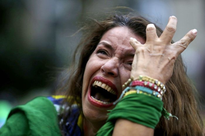 A Brazil soccer fan cries as Germany scores against her team at a semifinal World Cup match as she watches the game on a live telecast in Belo Horizonte, Brazil
