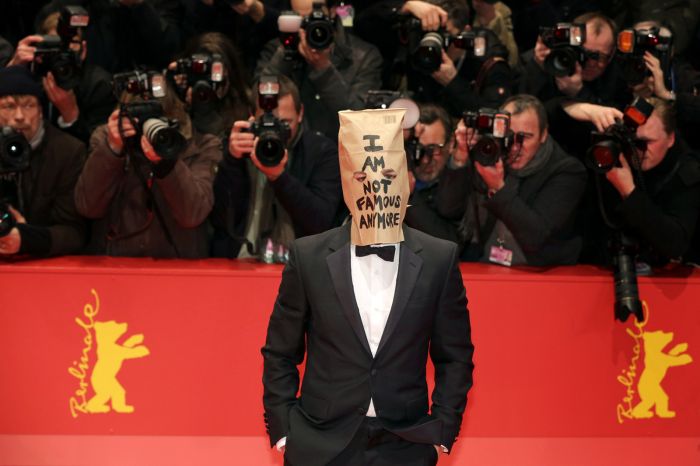 Actor Shia Labeouf wears a paper bag over his head reading I am not famous anymore as he arrives for the screening of Nymphomaniac Volume I at the 64th Annual Berlin Film Festival, in Berlin, Germany, Feb.