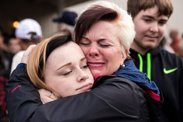 Colleen Epstein, right embraces her daughter, Meaghan Epstein left, a junior at Marysville Pilchuck High School, near the scene of a school shooting that left two dead and four wounded Friday, Oct. 24, at Marysville Pilchuck High School in Marysville, Wash.
