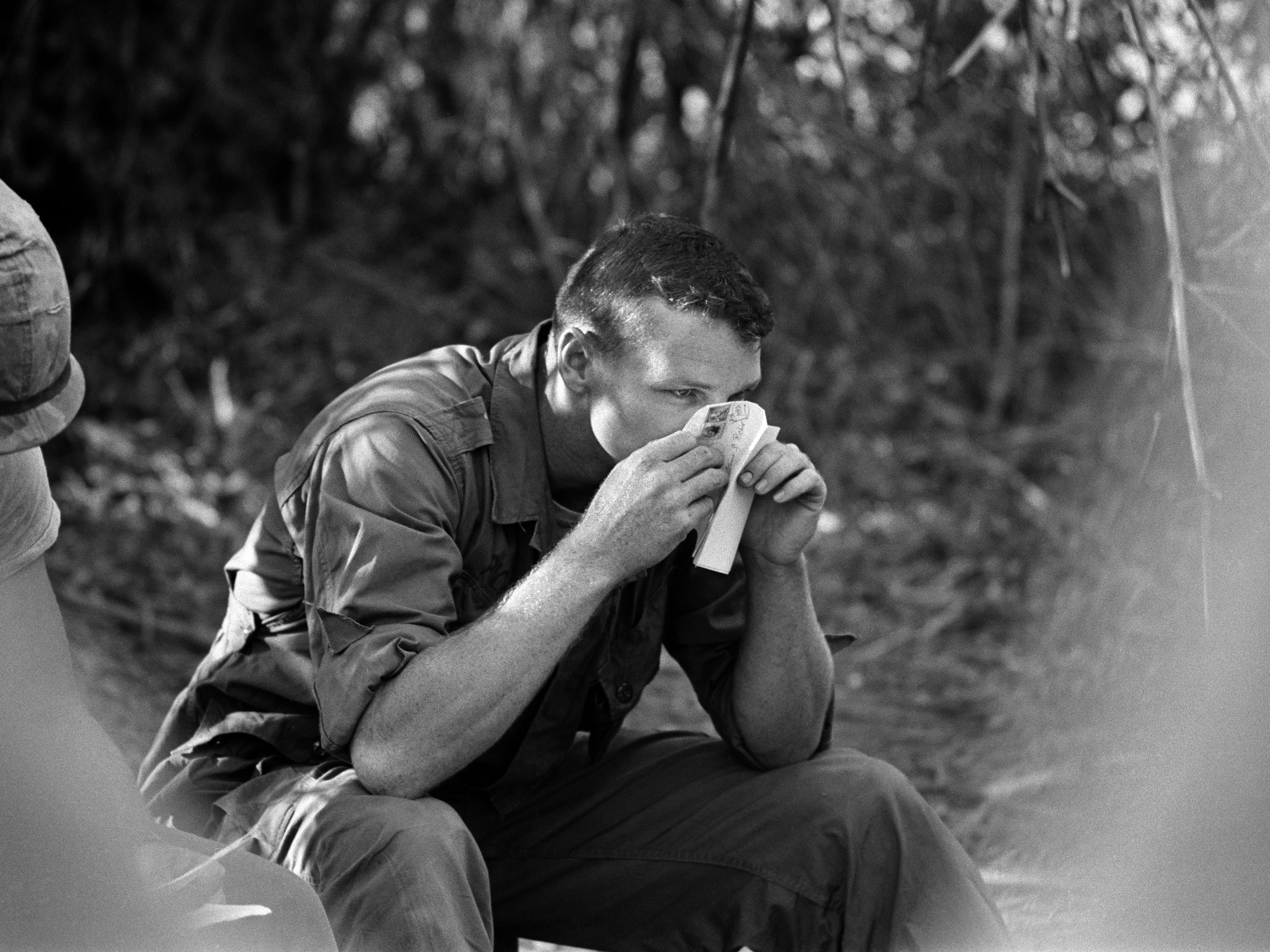 PFC Richie sniffs at the delicate perfume of his girlfriend in Jay, Oklahoma, as he opens her letter in Vietnam, April 12, 1966