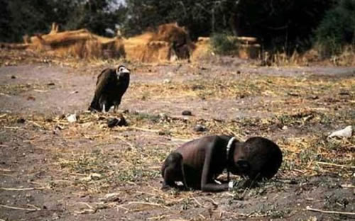 The photo is the “Pulitzer Prize” winning photo taken in 1994 during the Sudan Famine. The picture depicts stricken child crawling towards an United Nations food camp, located a kilometer away. The vulture is waiting for the child to die so that it can eat him. This picture shocked the whole world. No one knows what happened to the child, including the photographer Kevin Carter who left the place as soon as the photograph was taken. Three months later he committed suicide due to depression.